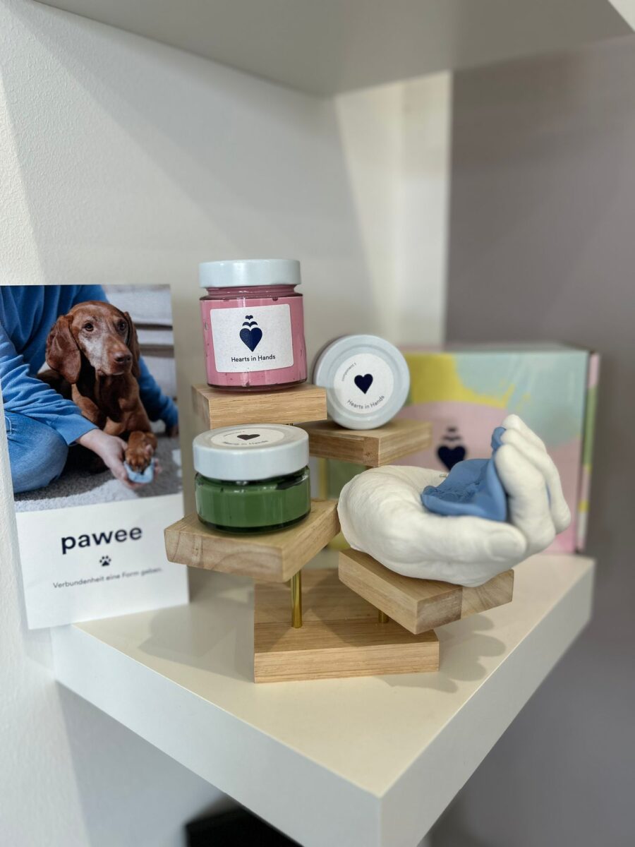 Jars of paw print compound stand on a shelf